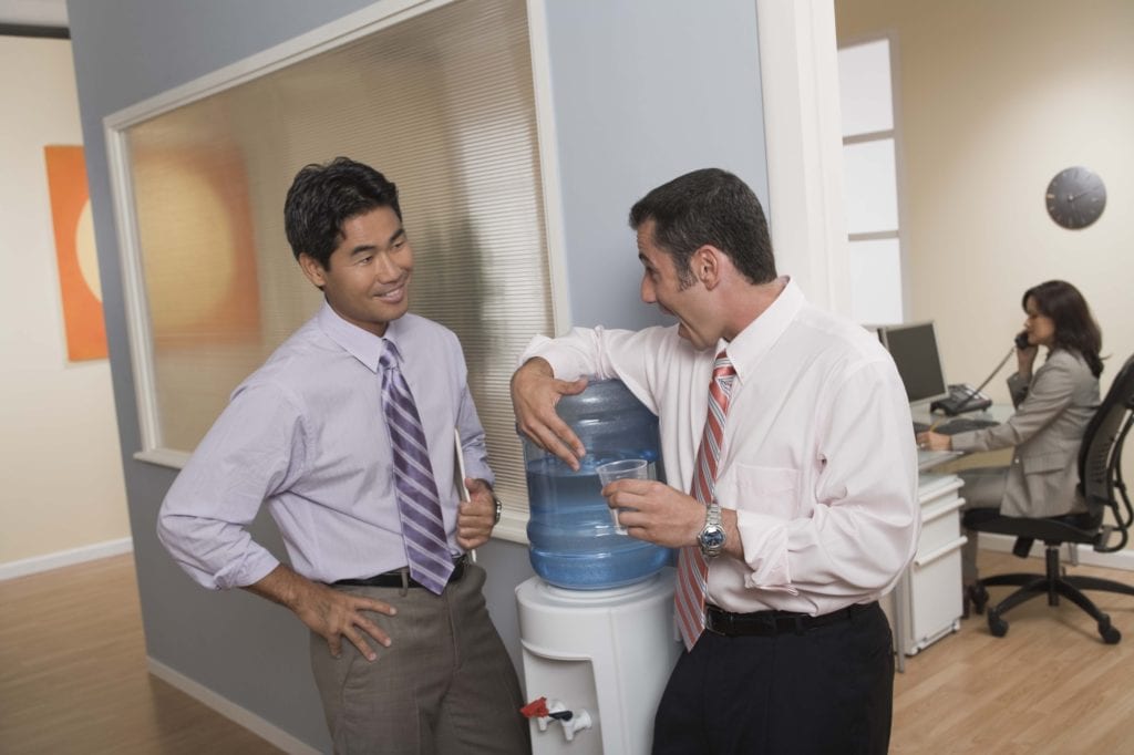 Image of two people at work bonding and building their professional relationships.